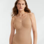 Woman in nude body suit.