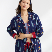 Woman wearing a set of pajamas and a blue robe.